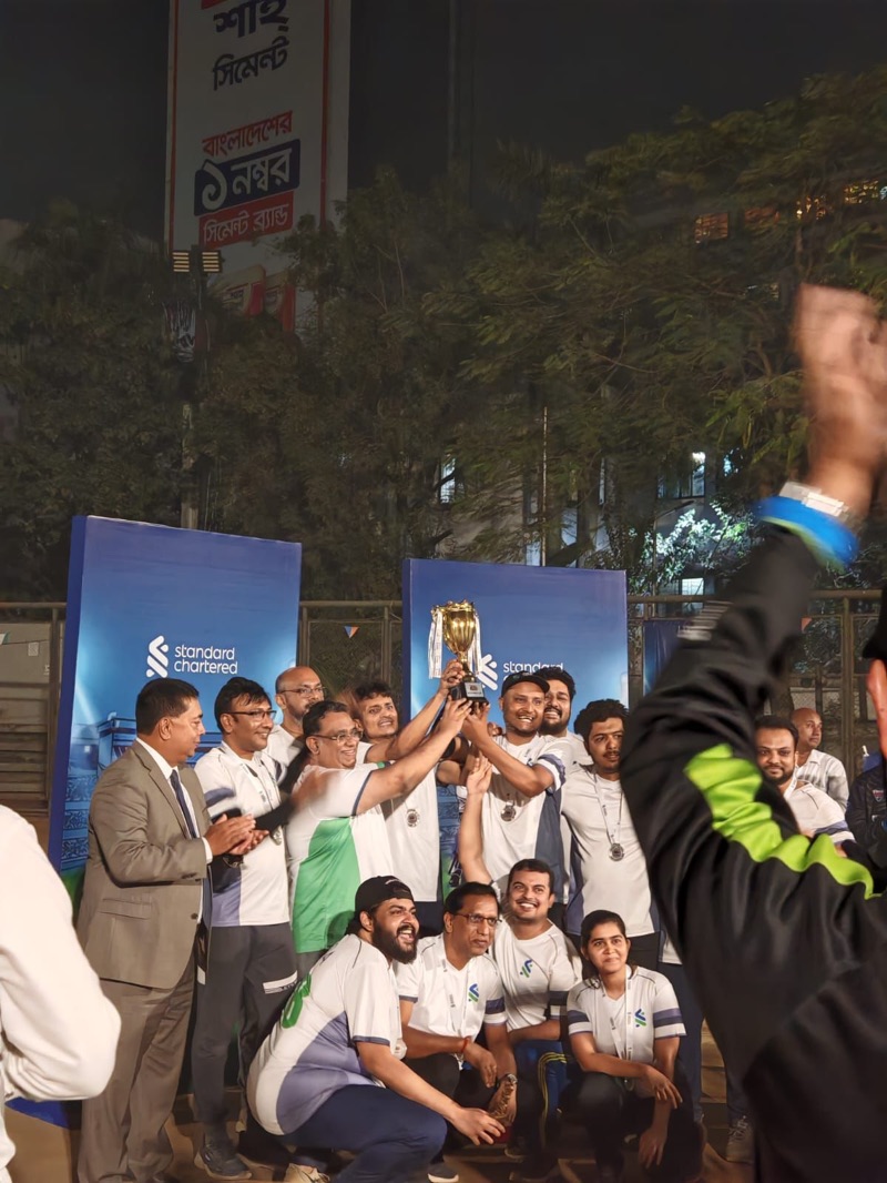 The Standard Chartered trade cricket team lifting the tournament trophy